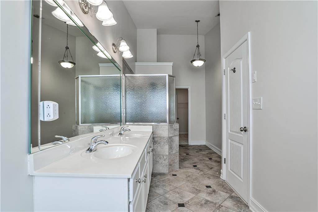 7 Reese Way Avondale Estates, GA 30002 - Photo 17 of 28 a bathroom with a sink a mirror and a shower