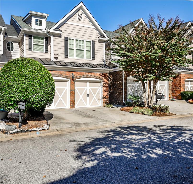 7 Reese Way Avondale Estates, GA 30002 - Photo 2 of 28 a front view of a house with a yard and garage