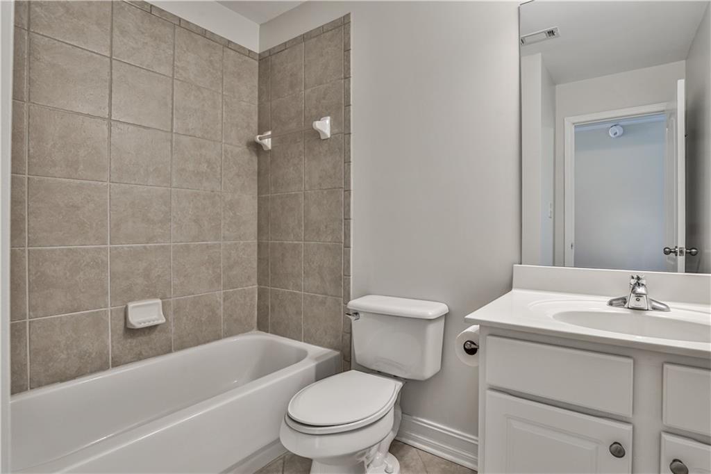 7 Reese Way Avondale Estates, GA 30002 - Photo 24 of 28 a bathroom with a sink a toilet a mirror a bathtub and shower