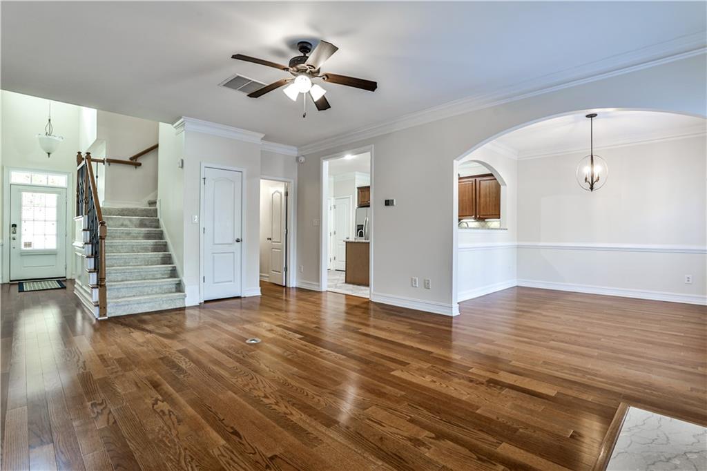 7 Reese Way Avondale Estates, GA 30002 - Photo 4 of 28 a view of an empty room with wooden floor and a ceiling fan