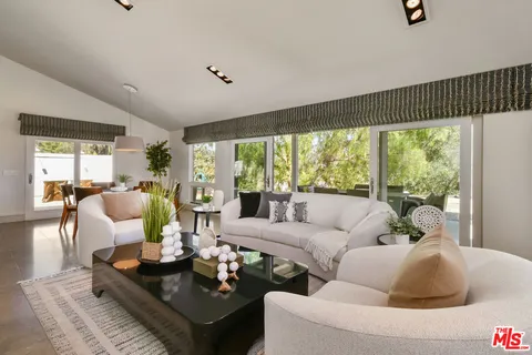 a view of a couches and a table in the backyard