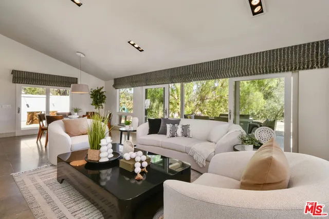 a view of a couches and a table in the backyard