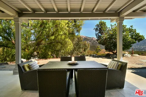 a living room with furniture a fireplace and a chandelier