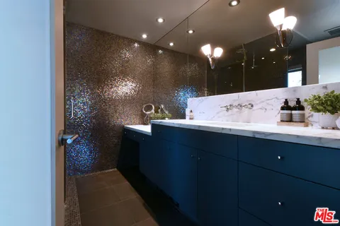 an aerial view of a house with swimming pool and patio