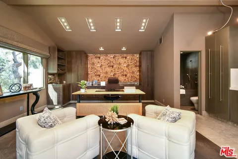 an aerial view of a house with a swimming pool and a yard