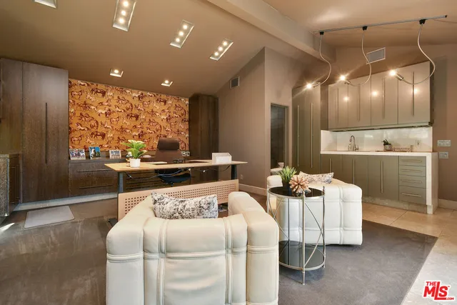 an aerial view of a house with a mountain