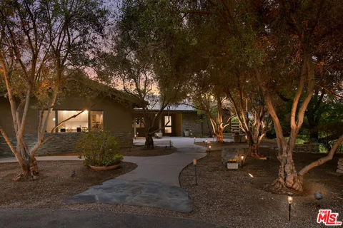 a backyard of a house with table and chairs