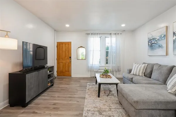 a kitchen with granite countertop white cabinets and refrigerator