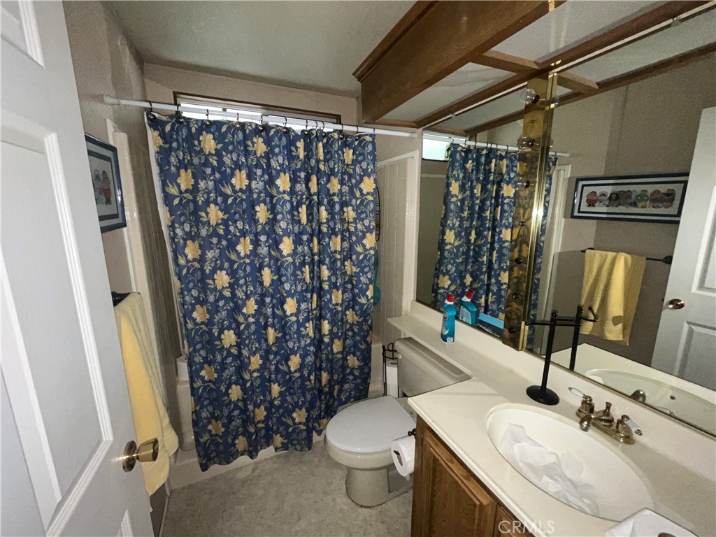 24600 Mountain Avenue, Unit 119 Hemet, CA 92544 - Photo 5 of 16 a bathroom with a sink toilet and shower