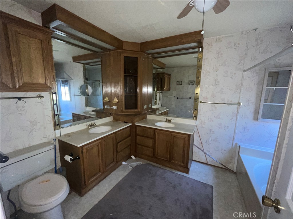 24600 Mountain Avenue, Unit 119 Hemet, CA 92544 - Photo 8 of 16 a bathroom with a granite countertop sink toilet and shower