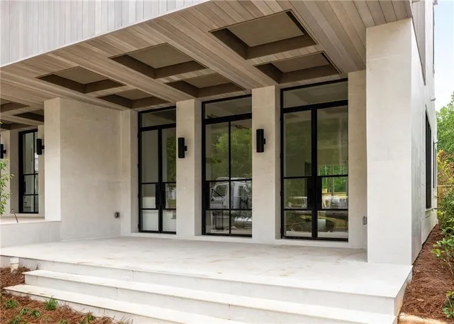 a large white kitchen with a large window
