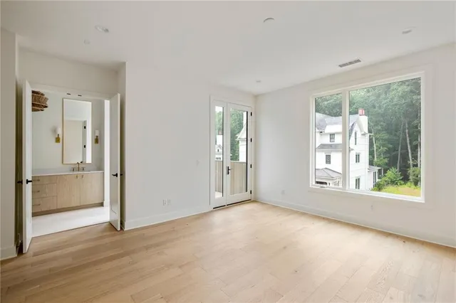a view of a bathroom with sink shower and mirror