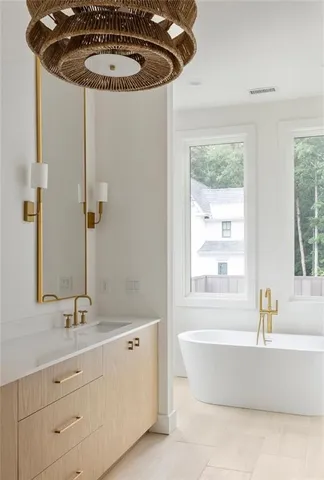 a bathroom with a double vanity sink mirror and a bathtub