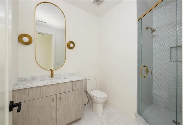 a bathroom with a granite countertop sink toilet a mirror and bathtub