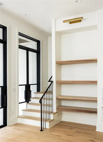 a view of staircase with lots of frames on wall
