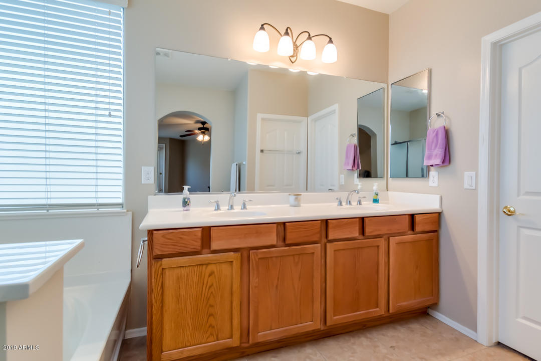 16528 West Sherman Street Goodyear, AZ 85338 - Photo 23 of 33 a bathroom with a double vanity sink and a mirror