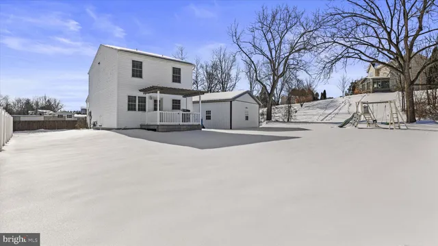 a view of a house with a snow in the yard