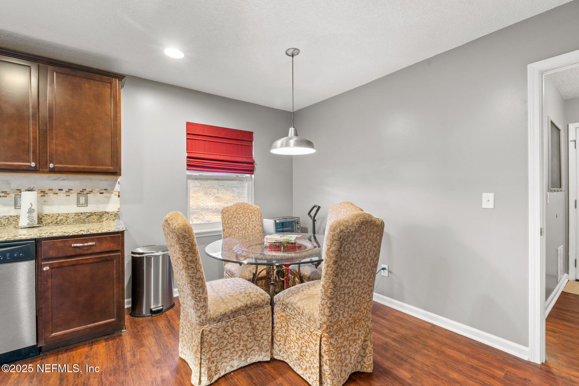 3301 Hermitage Road East Jacksonville, FL 32277 - Photo 20 of 49 a dining room with furniture and wooden floor