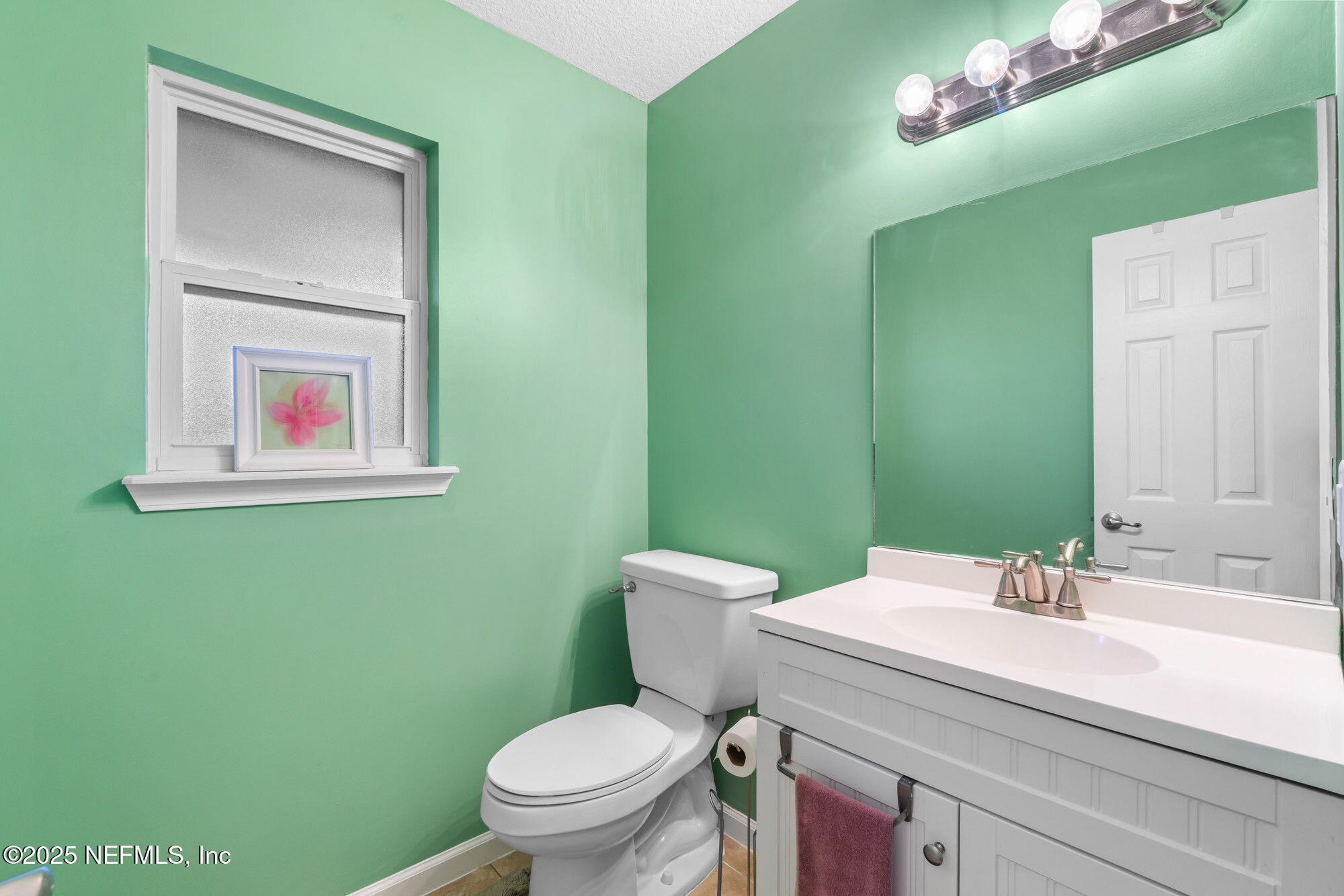 3301 Hermitage Road East Jacksonville, FL 32277 - Photo 21 of 49 a bathroom with a toilet sink and mirror
