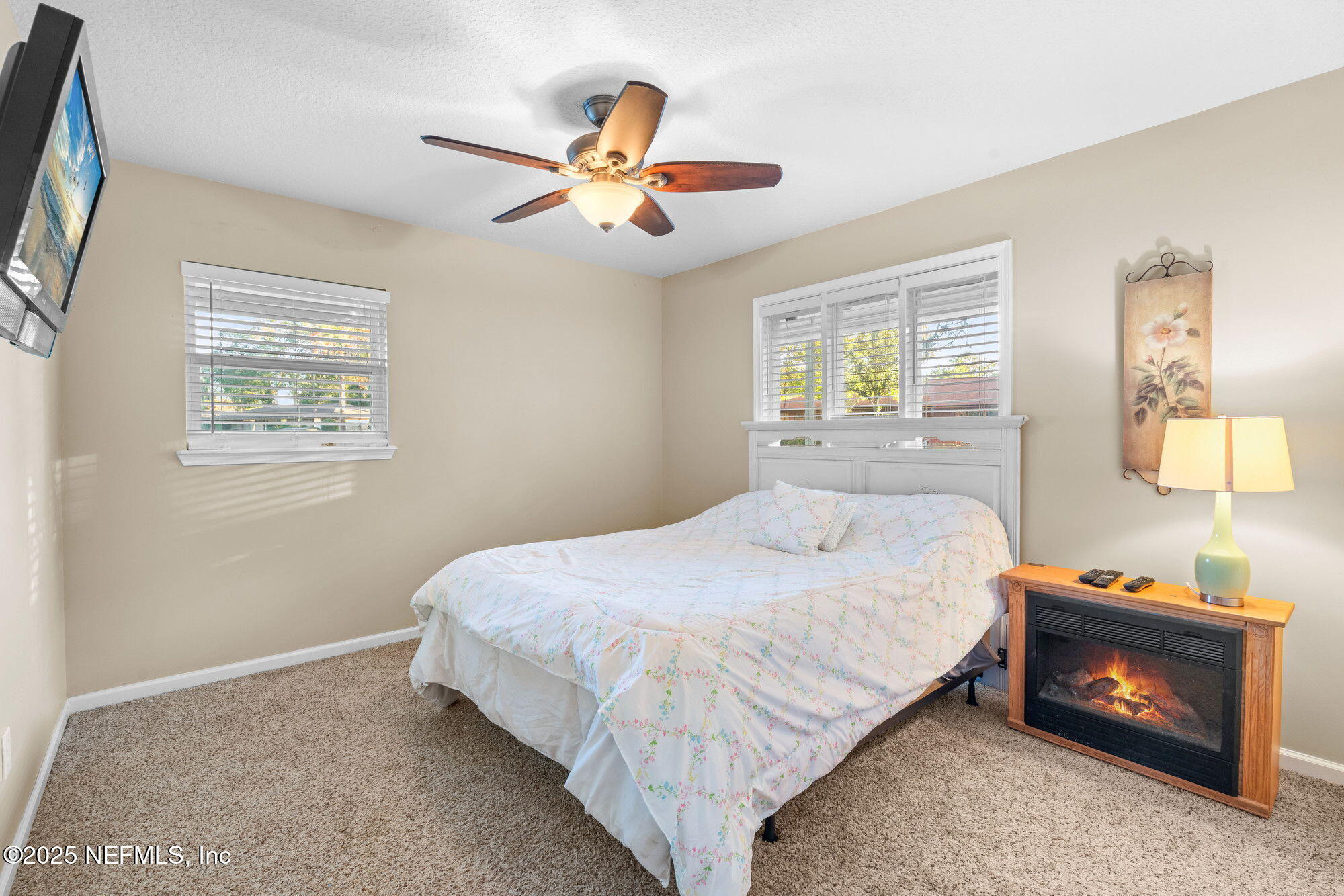 3301 Hermitage Road East Jacksonville, FL 32277 - Photo 32 of 49 a bedroom with a bed and a chandelier