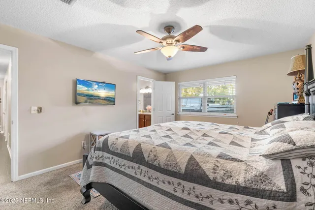 a room with a wooden floor and potted plant