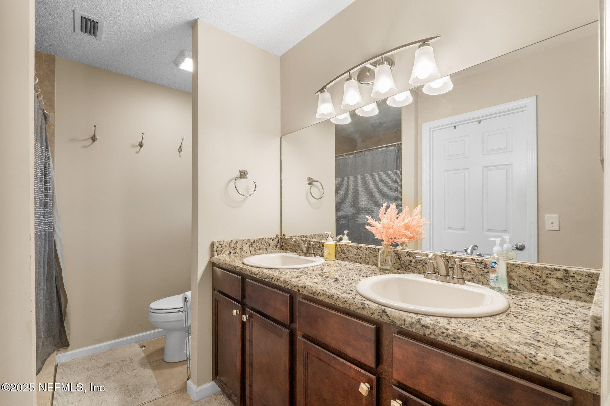3301 Hermitage Road East Jacksonville, FL 32277 - Photo 35 of 49 a bathroom with a granite countertop sink a toilet and a mirror