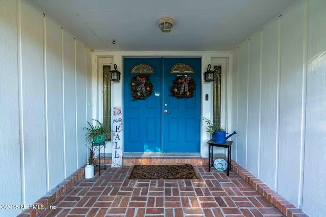 a view of a hallway with bathroom view