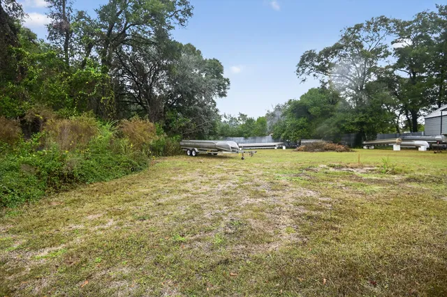 a view of a swimming pool and trees in the background