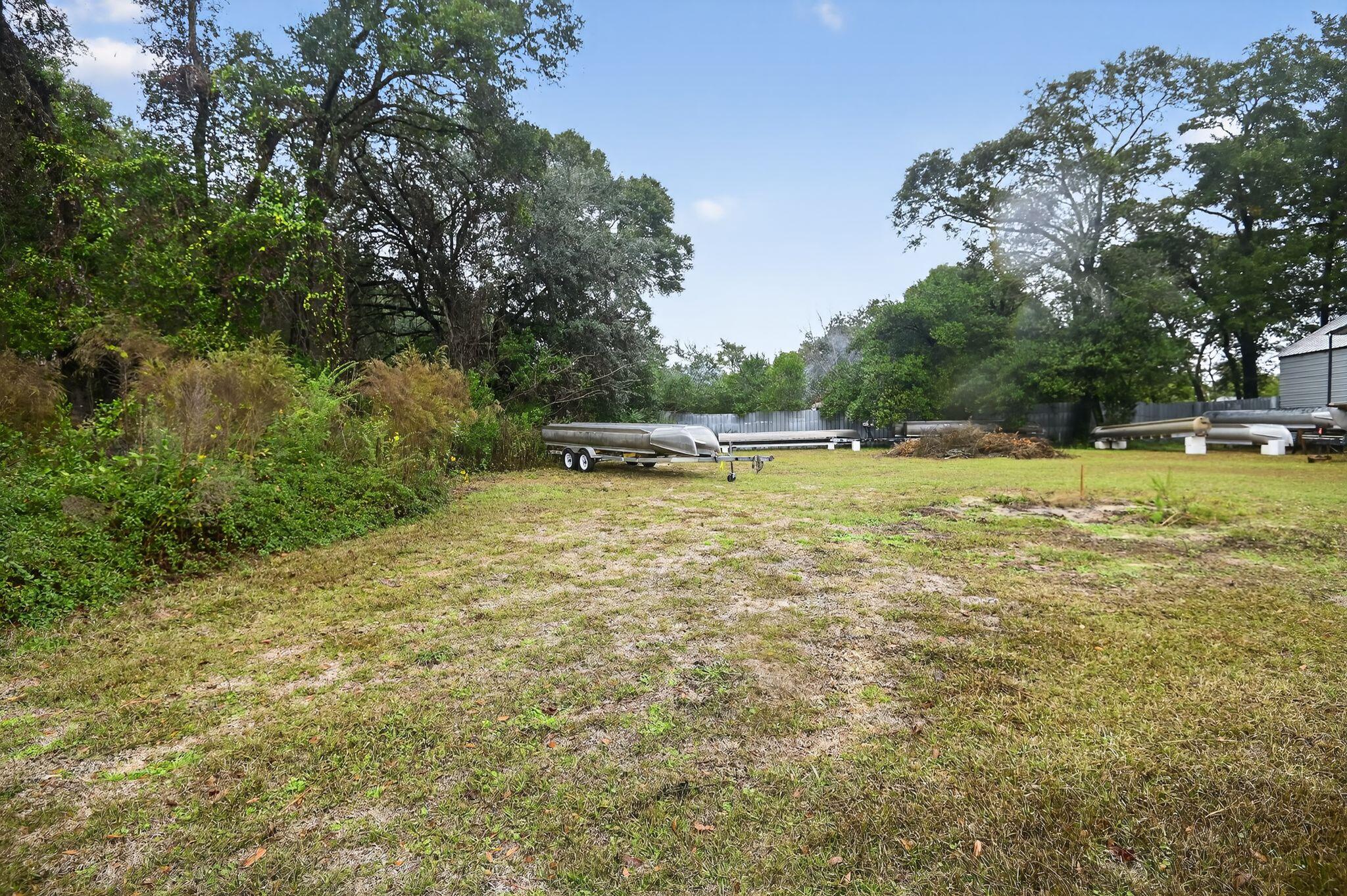 a view of a swimming pool and trees in the background