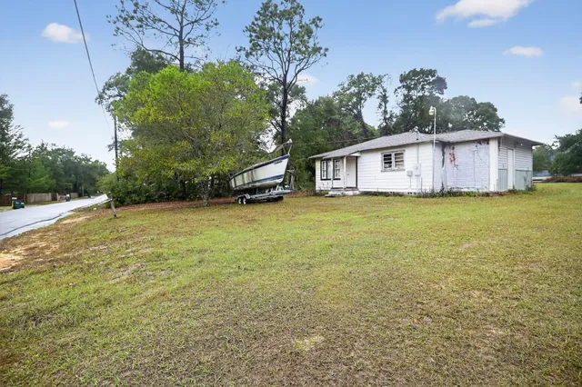 a view of a house with a yard and garage