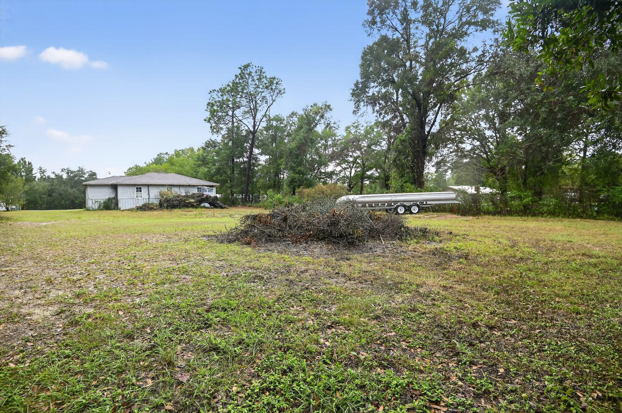 950 B Street Crestview, FL 32536 - Photo 7 of 32 a view of a swimming pool with a yard and trees