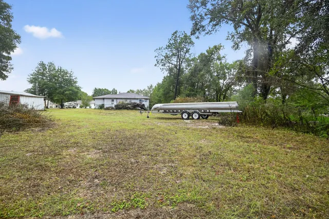 a view of a house with garden and trees