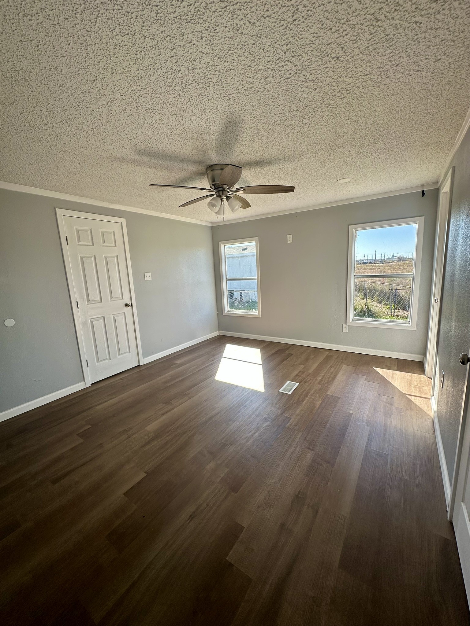 2529 Mcdonald Road Oyster Creek, TX 77541 - Photo 12 of 14 a view of an empty room with wooden floor and a window