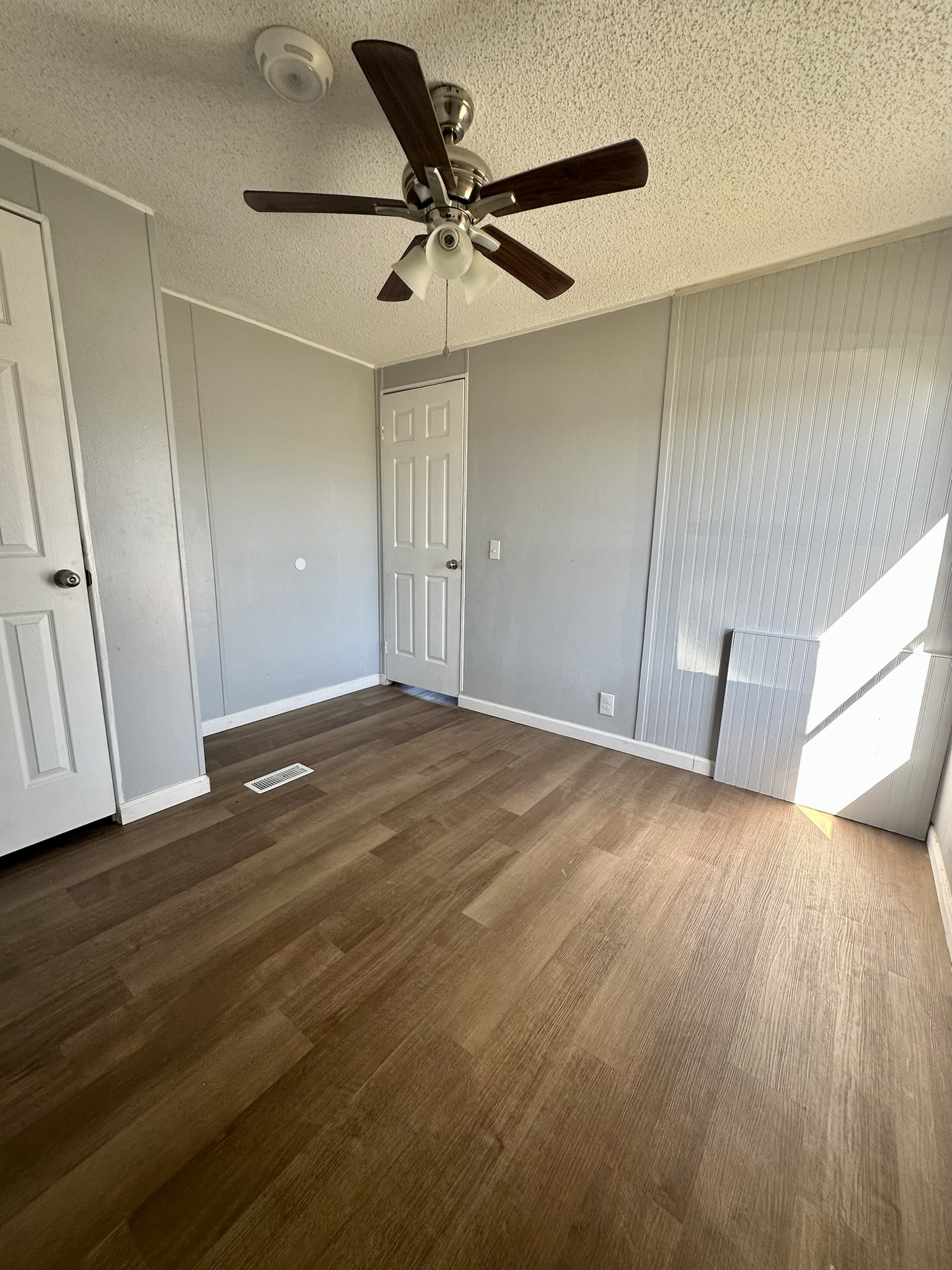 2529 Mcdonald Road Oyster Creek, TX 77541 - Photo 6 of 14 a view of a livingroom with a ceiling fan and wooden floor