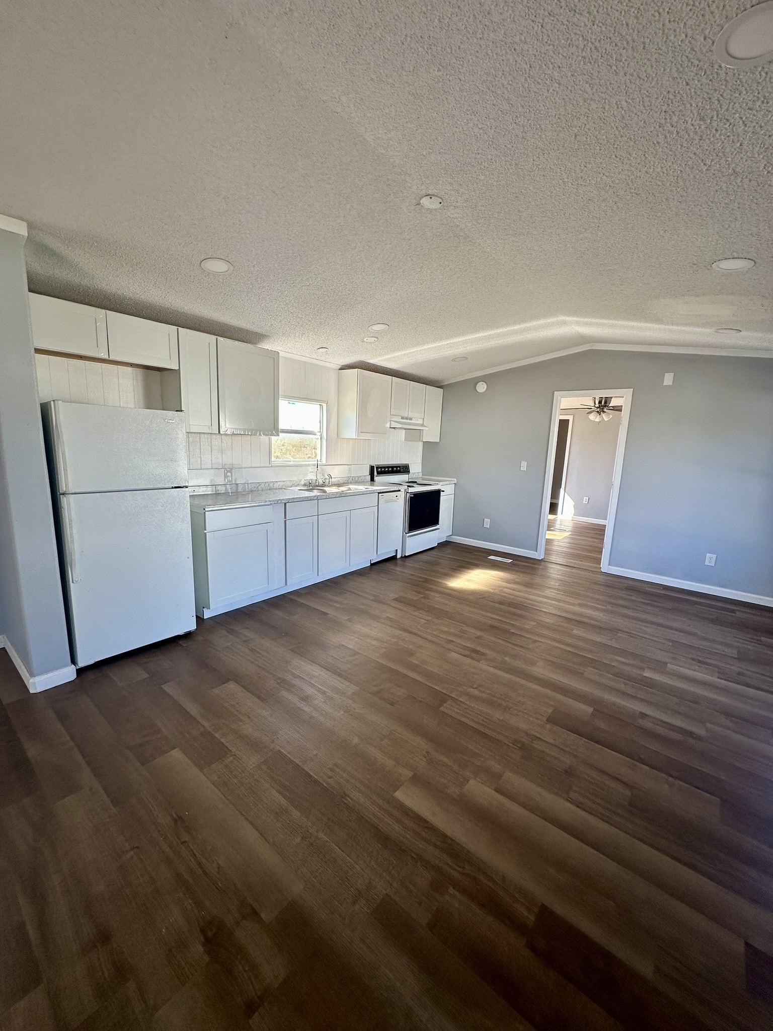 2529 Mcdonald Road Oyster Creek, TX 77541 - Photo 8 of 14 a view of a kitchen with a sink and dishwasher stove top oven with wooden floor