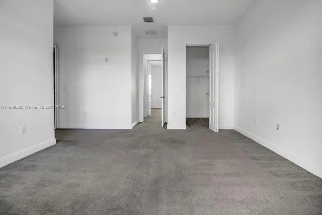 an empty room with closet area
