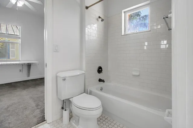 a bathroom with a toilet and a bathtub