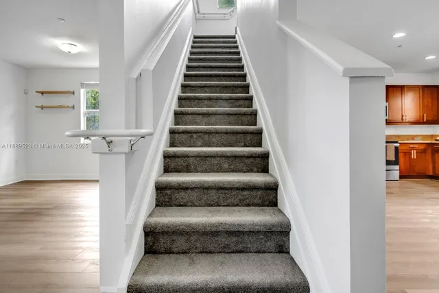 a view of entryway and hall with wooden floor