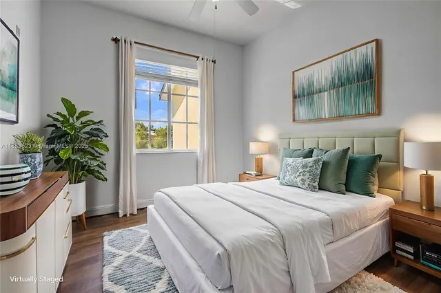 a bedroom with bed and a potted plant