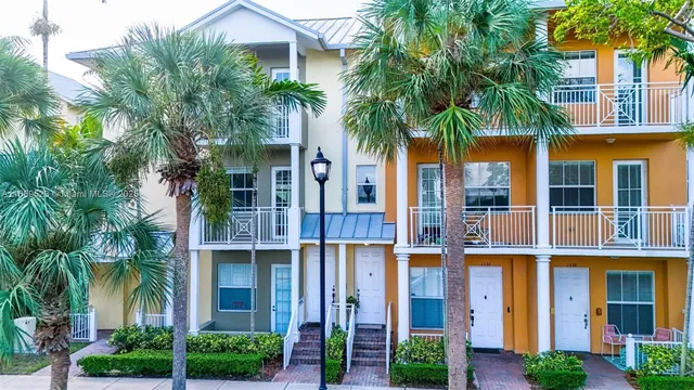 front view of house with a palm plants