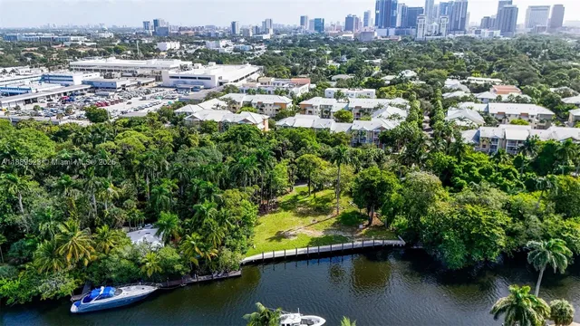 an aerial view of residential houses with outdoor space and lake view
