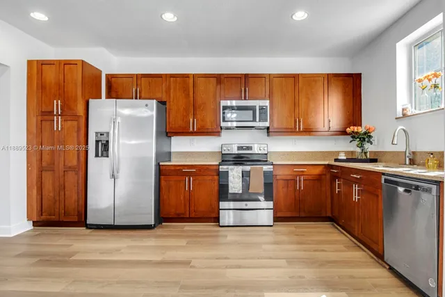 a kitchen with stainless steel appliances a refrigerator and a sink