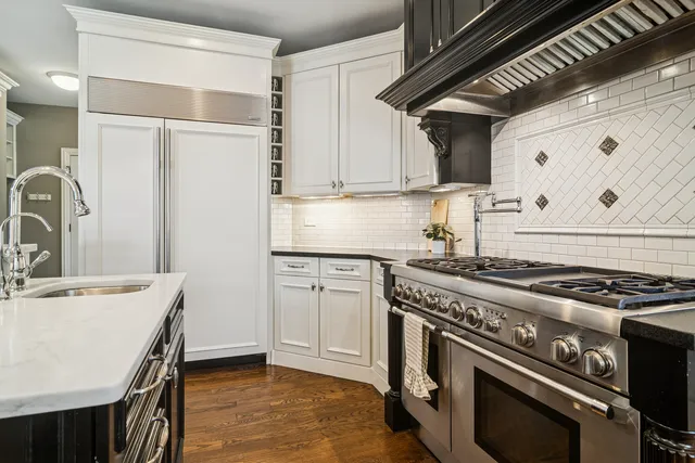 a white stove top oven sitting inside of a kitchen
