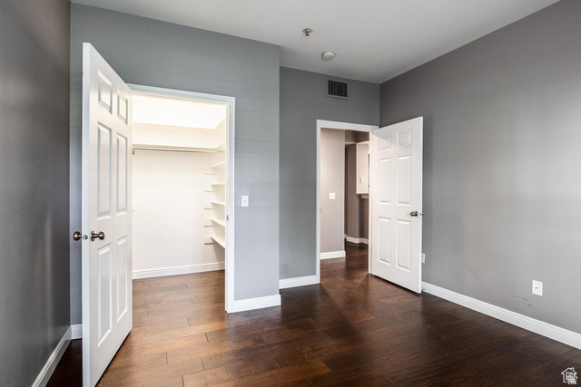 900 Bitner Road, Unit M 17 Park City, UT 84098 - Photo 12 of 29 Unfurnished bedroom featuring dark wood finished floors and a spacious closet