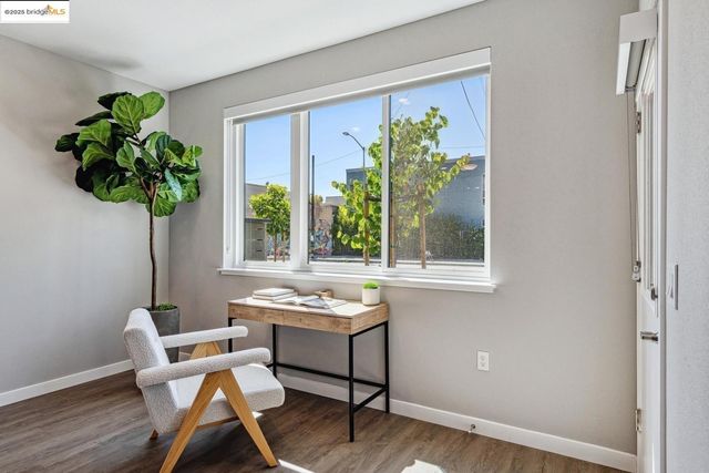 a dining room with furniture potted plants and wooden floor