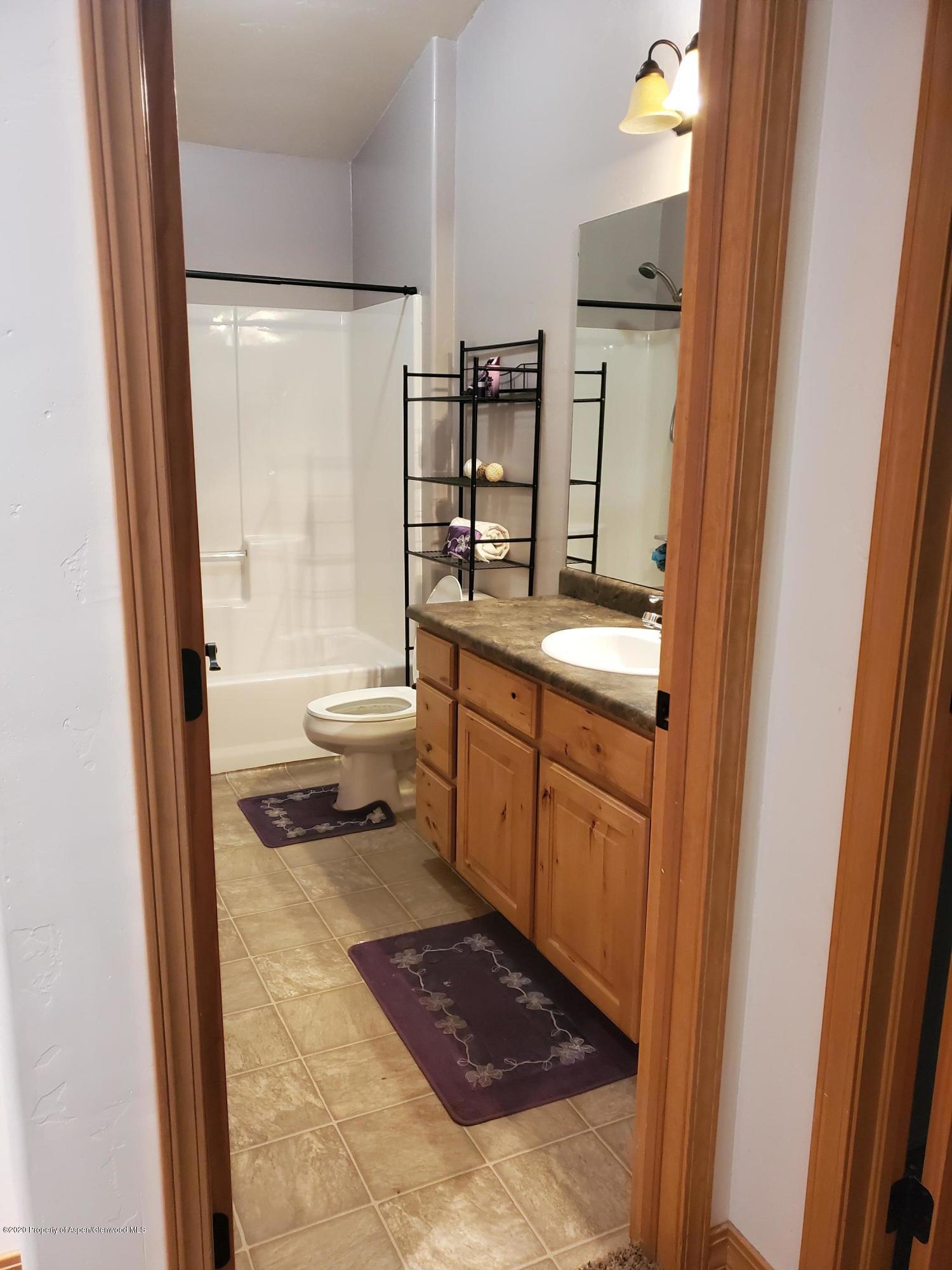 1880 Anvil Court Rifle, CO 81650 - Photo 11 of 16 a bathroom with a granite countertop sink toilet and shower