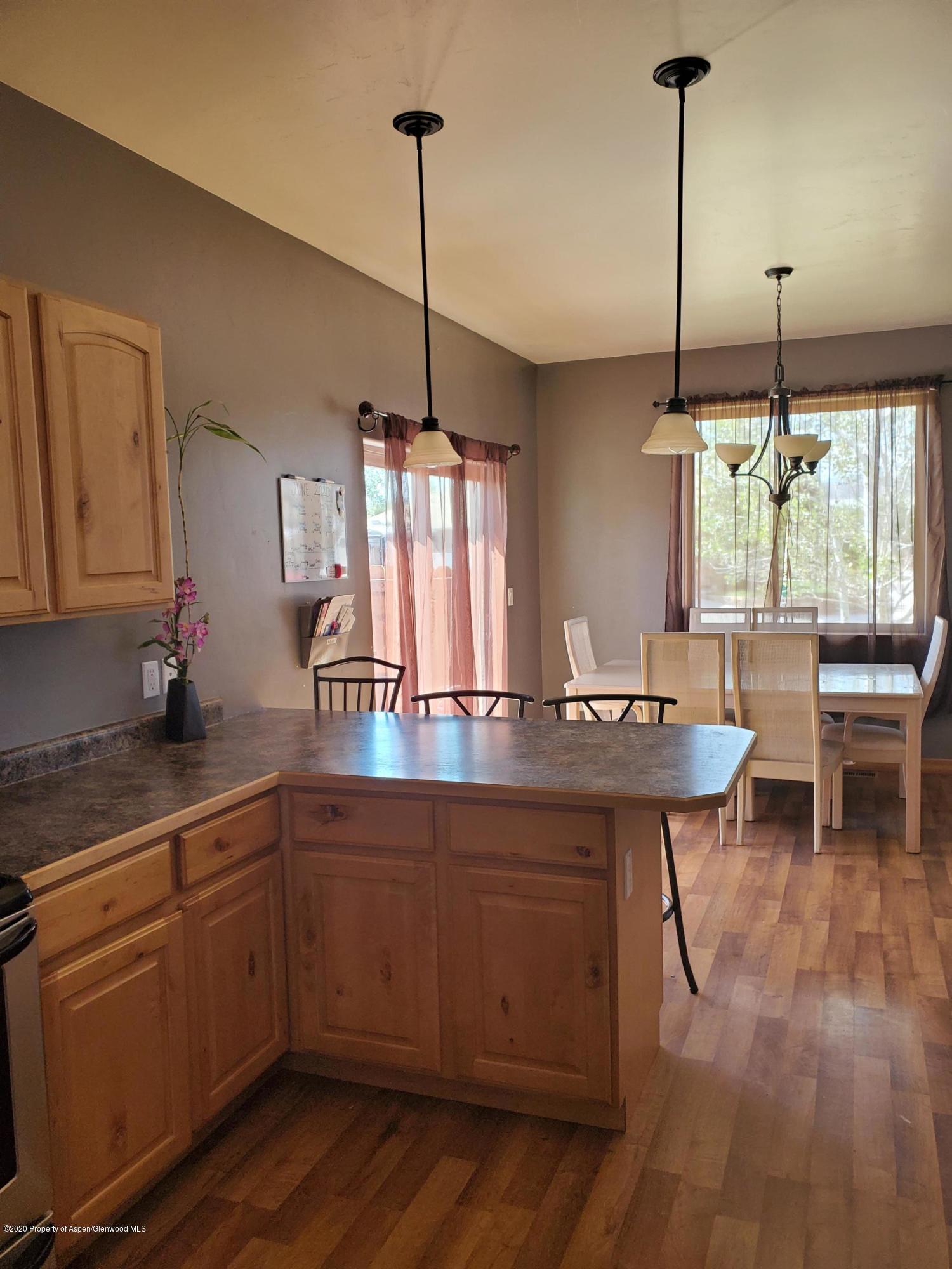 1880 Anvil Court Rifle, CO 81650 - Photo 5 of 16 a kitchen with kitchen island granite countertop a sink a counter space appliances and cabinets