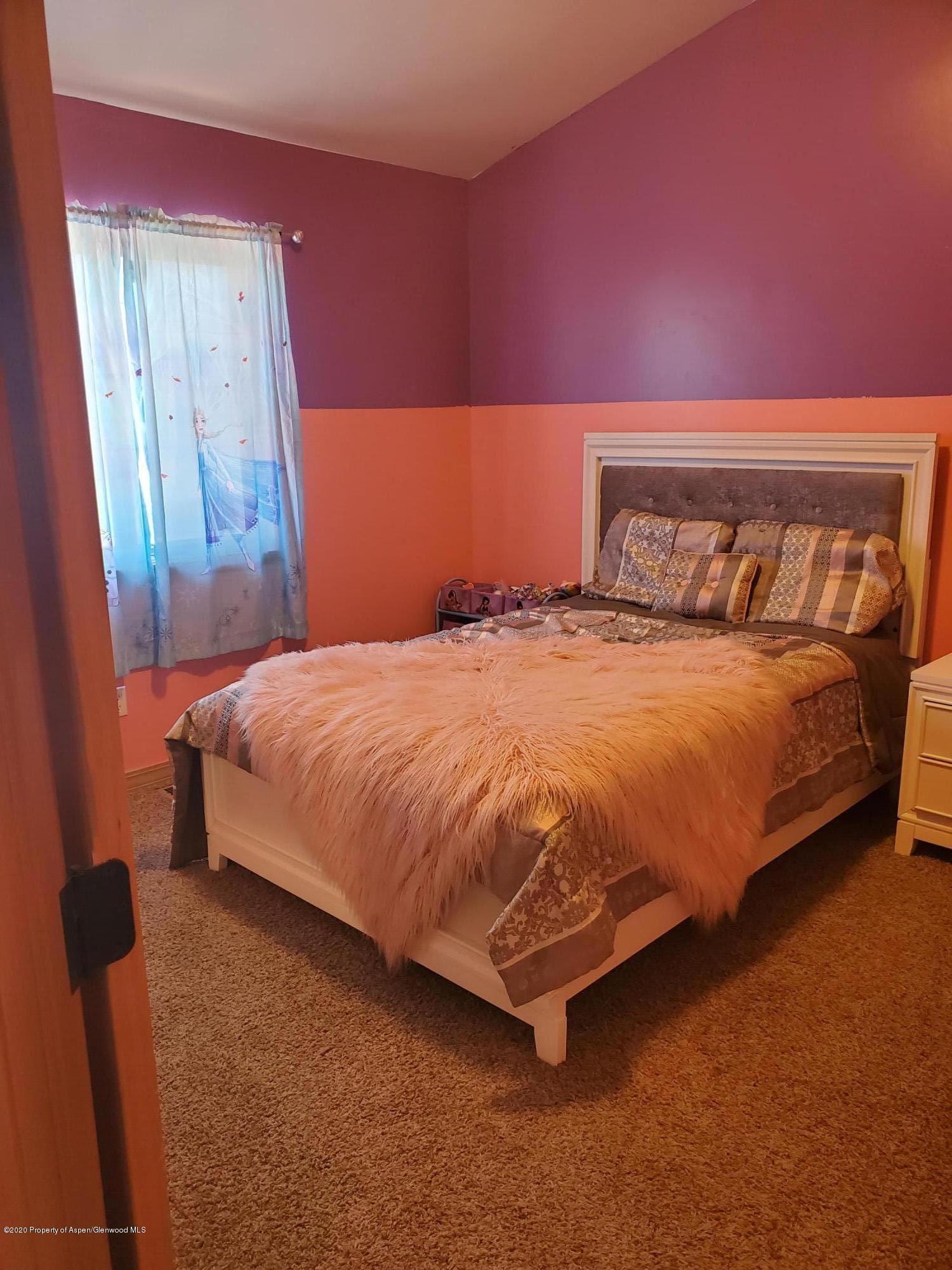 1880 Anvil Court Rifle, CO 81650 - Photo 7 of 16 a bedroom with a bed and a mirror