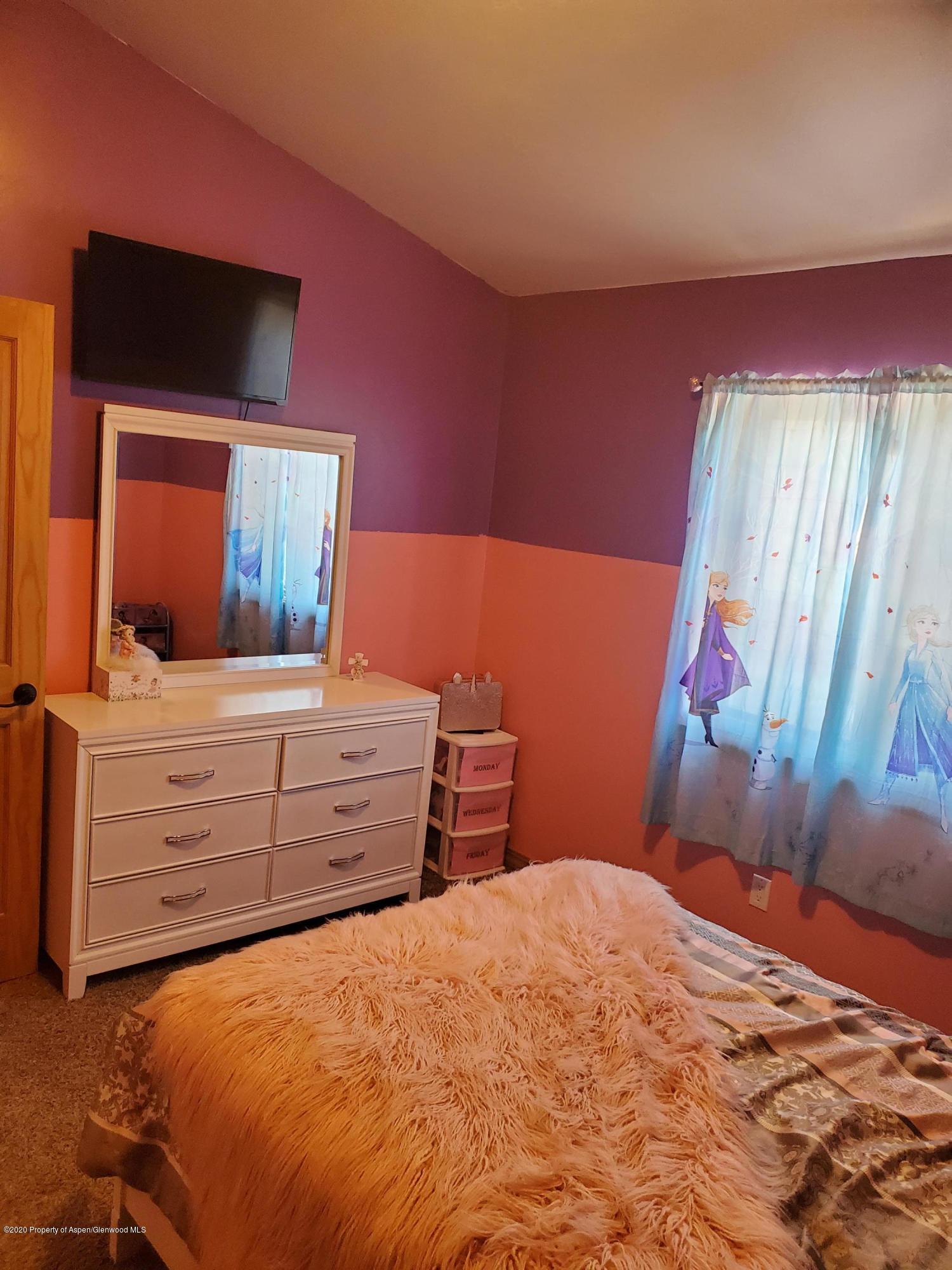 1880 Anvil Court Rifle, CO 81650 - Photo 8 of 16 a bedroom with a bed and a flat screen tv