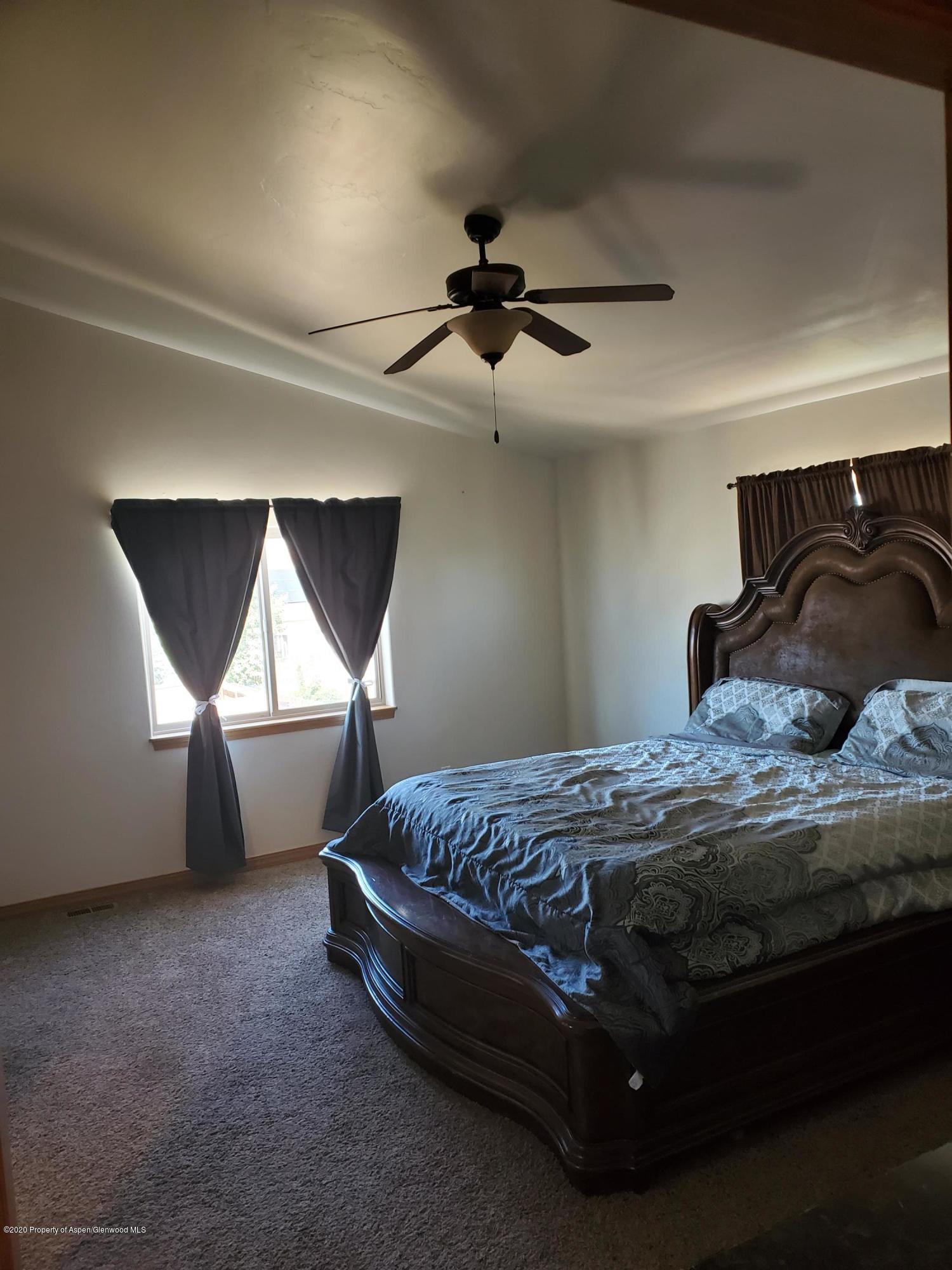 1880 Anvil Court Rifle, CO 81650 - Photo 10 of 16 a bedroom with a bed and a window